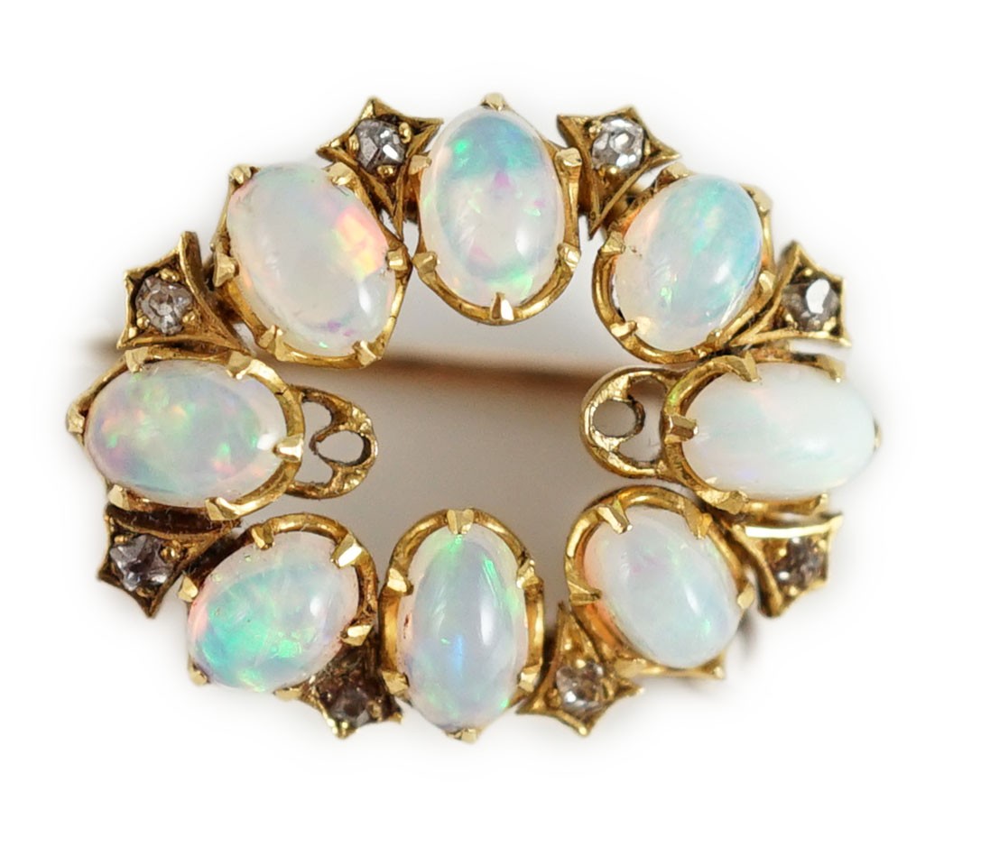 An Edwardian gold, eight stone oval opal set oval brooch, with diamond chip spacers